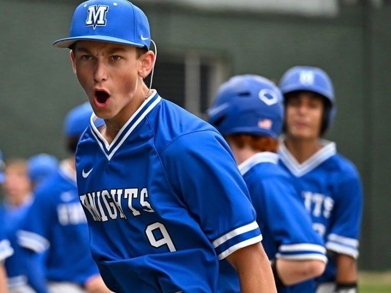 Baseball player celebrating with teammates in background